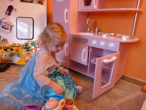 Allison (Elsa) playing with her new kitchen on Christmas morning